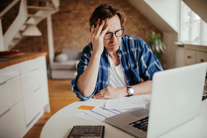 Man looking upset at a computer